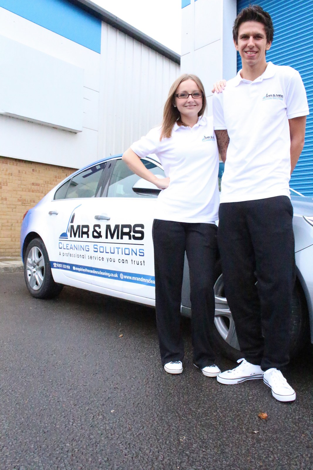 Jo and Jason, founders of Mr & Mrs Cleaning Solutions, beside their branded company car